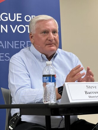 Candidate speaks while seated at table