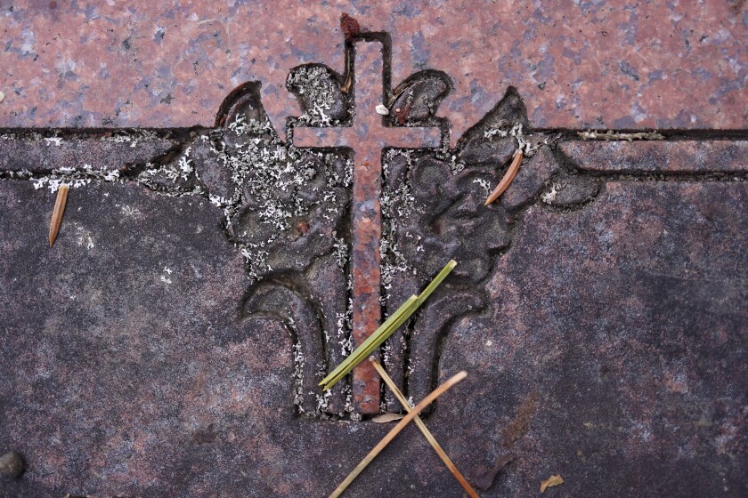 woman documents gravestones
