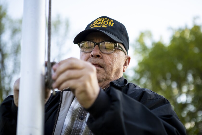 Allan Simon ties off a halyard after raising an American flag at the Flags of Honor Memorial on Friday, May 27, 2022, in preparation for Memorial Day on Monday.