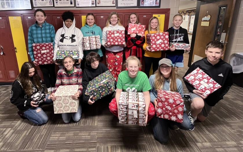Students at Ellsworth Public School show the presents from the Share Tree on Tuesday, Dec. 20, 2022.