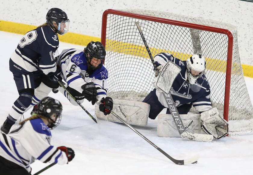 Proctor/Hermantown’s Hannah Graves (6) squeezes between Hibbing’s Annika Lundell (18) and goalie Addison Hess (30) as she tries to put the puck in the net