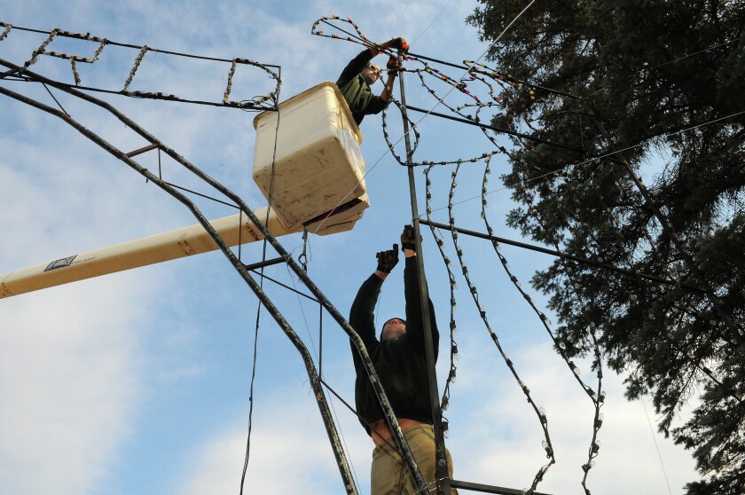 Mike’s Tree Service employees Troy Christensen (top) and Mike Olson stabilize one of the lighting displays for the Brainerd Sertoma Winter Wonderland at the Northland Arboretum Wednesday. The holiday display opens Nov. 11 at 5:30 p.m. and continues through the Christmas season. Mike’s Tree Service and Sertoma volunteers were busy Wednesday beginning the process of erecting the large lighting displays. Brainerd Dispatch/Steve Kohls