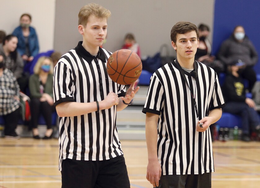 Evan Bennett, left, and Robert Olson, both senior captains on the Superior High School basketball team, chat between quarters of a Superior Basketball Association Mini-Ballers game