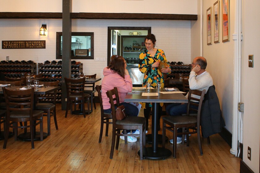 Brighid Maguire, owner of Spaghetti Western talks with diners on Feb. 9, 2024.