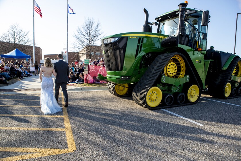 A couple rolls up in a John Deere 9620RX during the grand march of the Willmar High School prom on Friday, May 6, 2022.