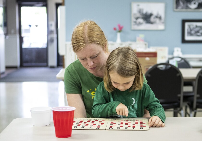 Mother Nicole Konz and Kyan Arnhold, 4, play bingo together at the Willmar Community Center during Garden Bingo on Tuesday August 23, 2022.