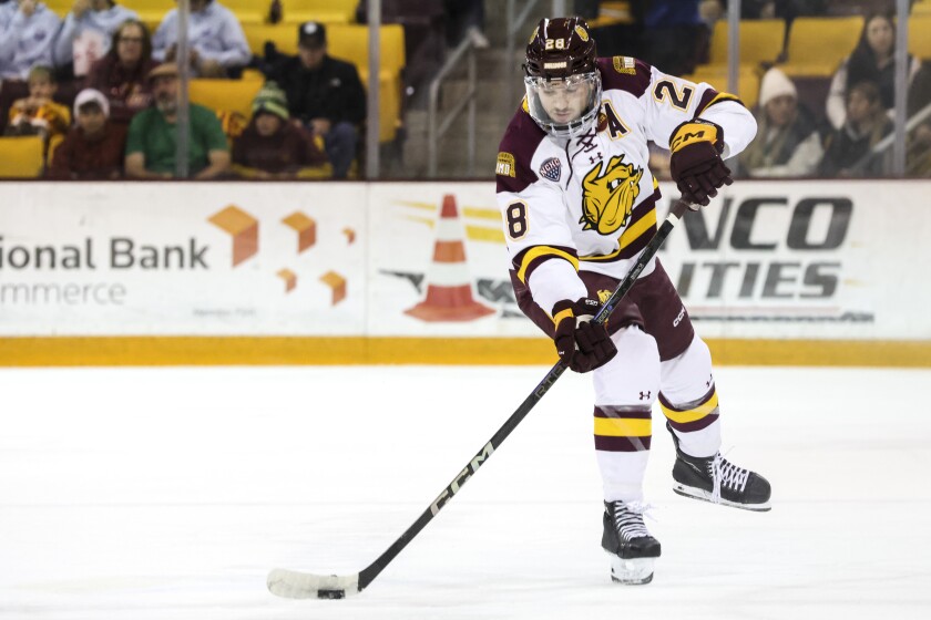 college men play ice hockey