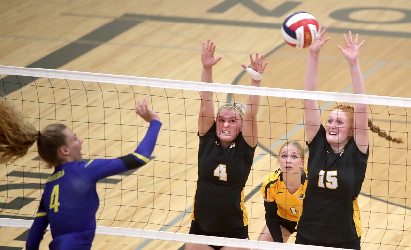Northwestern’s Brinley Tonn (4) and Sophie Korn (15) try to block an attack by Rice Lake’s Eliana Sheplee (4)