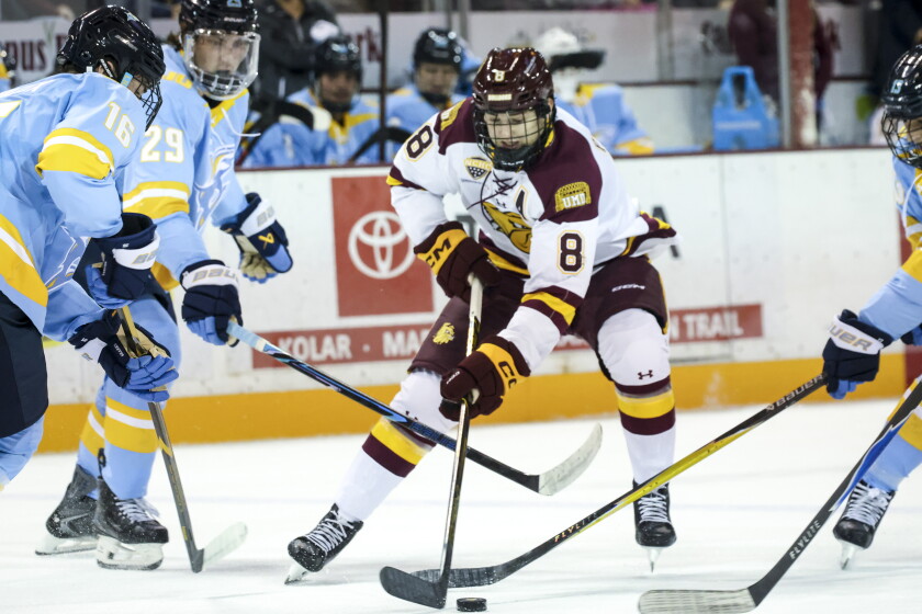 college men play ice hockey indoors
