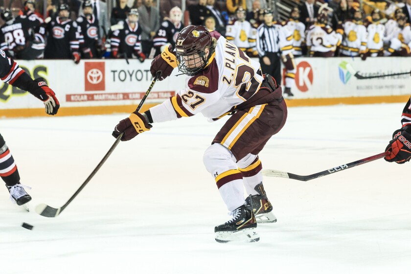 college men play ice hockey