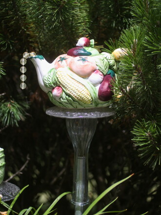 Marlene Olson makes garden art out of glassware, china, and curios that were either thrifted or found on clearance at local stores. She sells her creations and decorates her yard with them.