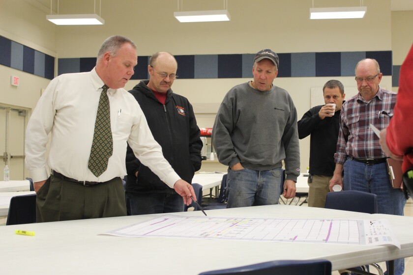 Bill Moran, left, who is South Dakota Regional Transportation Director for consulting firm HR Green, points to a large map during Tuesday's stakeholder meetings at the Davison County Fairgrounds west of Mitchell. (Marcus Traxler/Republic)