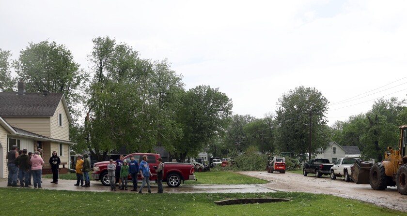 Crews remove downed trees on 2nd St. in Rushmore Minnesota from severe thunderstorms early am hours Monday morning.