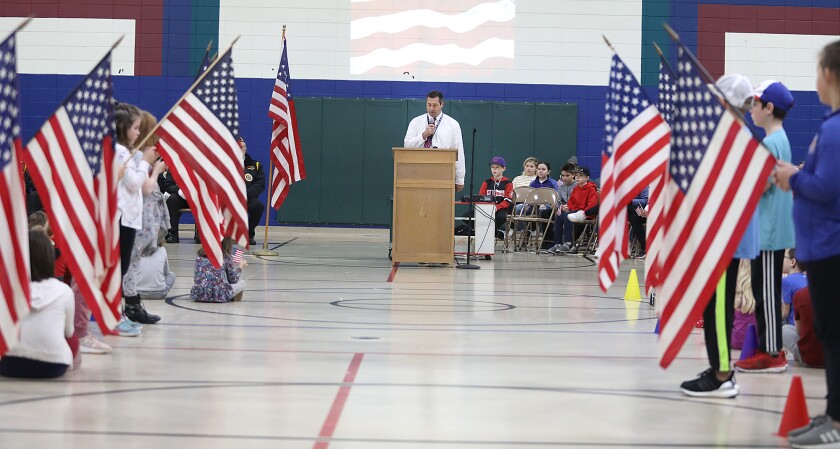 Principal Ryan Haroldson speaks to the crowd at Great Lakes Elementary School during their Veteran’s Day ceremony