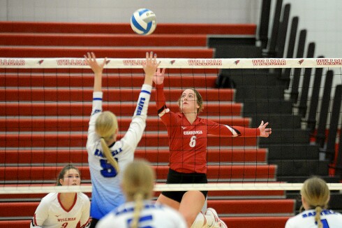 Willmar sophomore Gretchen Volk, 6, tips the ball over the net during a Central Lakes Conference match against Sartell on Tuesday, Sept. 27, 2022 at the Big Red Gym at Willmar High School.