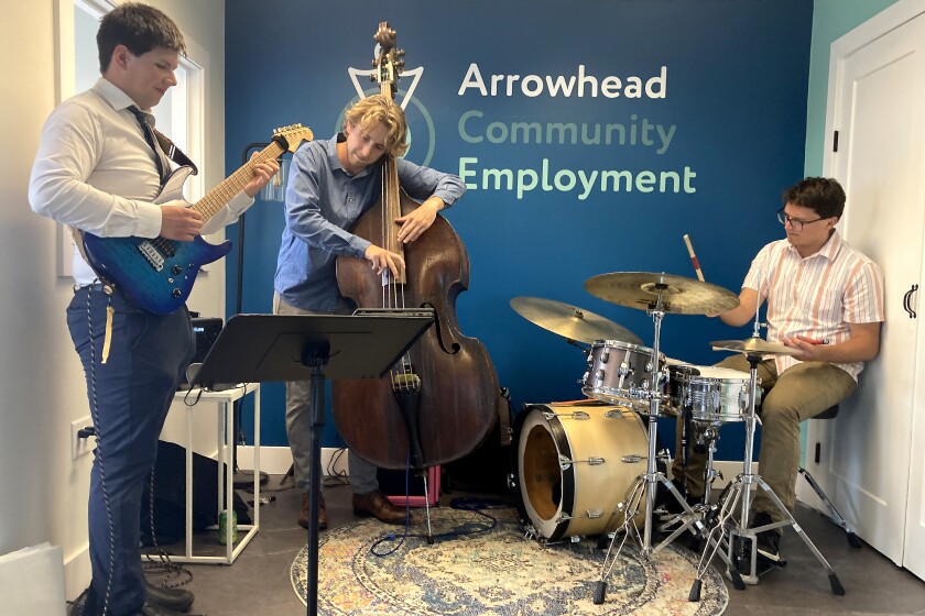 A jazz band playing inside of a business during an appointment.