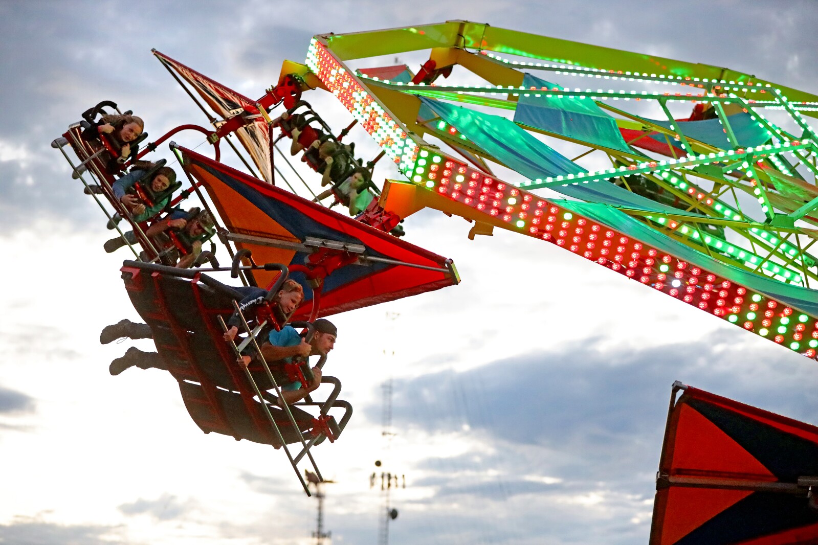 The fair midway ride Soarin' spins people around.