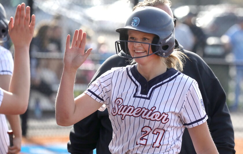 Superior’s Emma Raye (27) gets a high five as she walks back to the dugout after hitting a home run