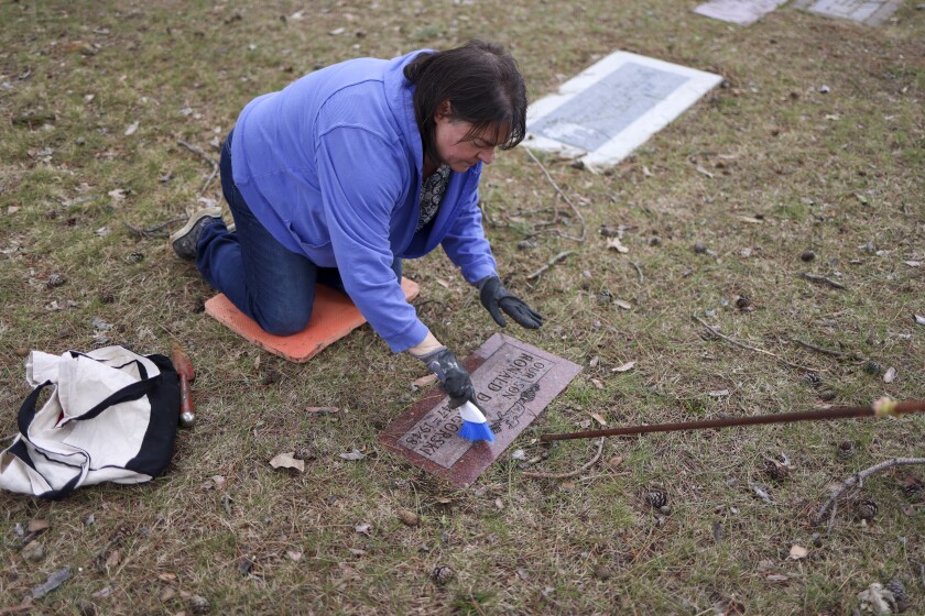 woman documents gravestones