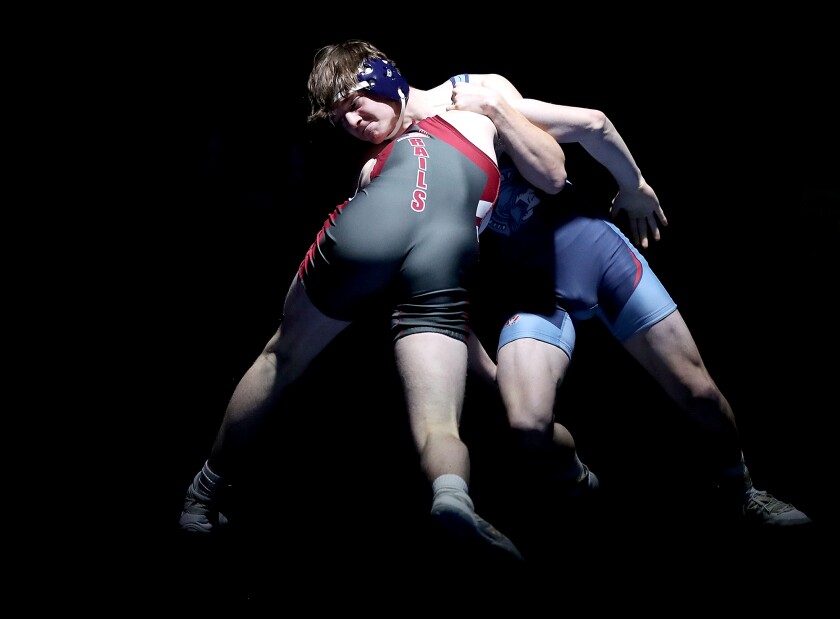 Superior’s Wyatt Mitchell gains control of Spooner’s Conner Burke during their match at 170 pounds