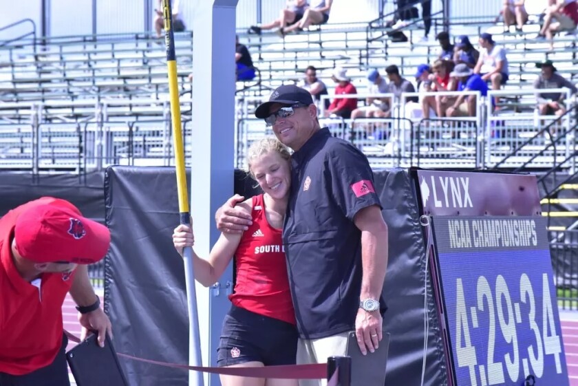South Dakota assistant coach Derek Miles hugs pole vaulter Deidra Marrison at the NCAA West Preliminary Round meet Thursday, May 27, 2021, in College Station, Texas.