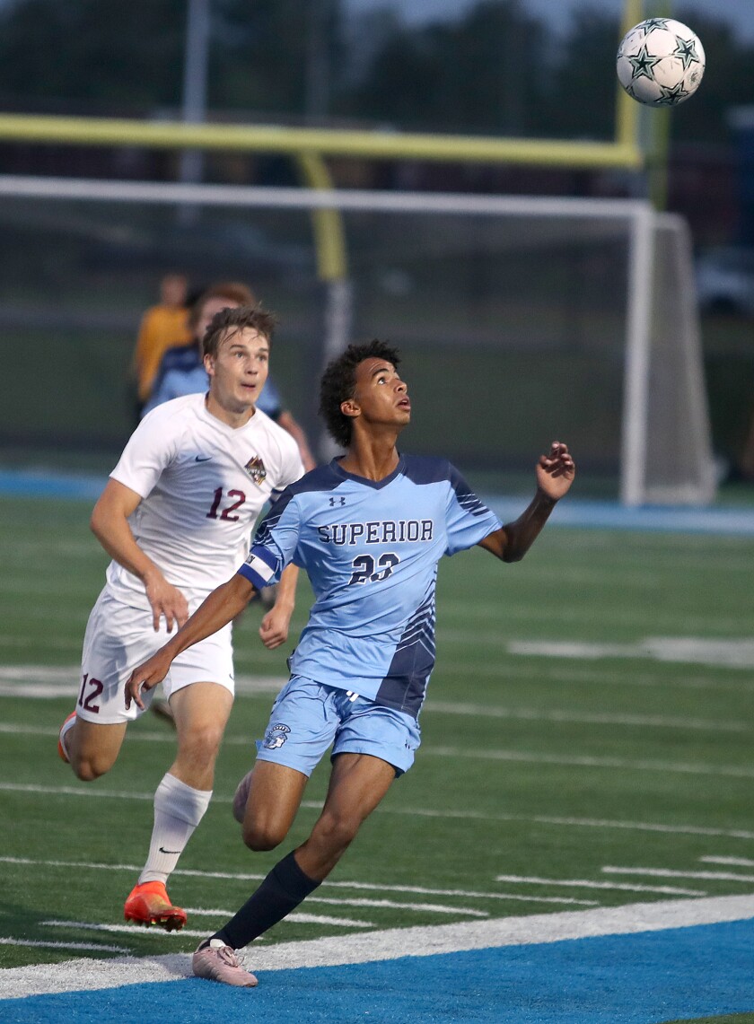 Superior’s Diedrick Nikoi (23) gets under a bouncing ball in front of Duluth Denfeld’s Brayden Rock (12)