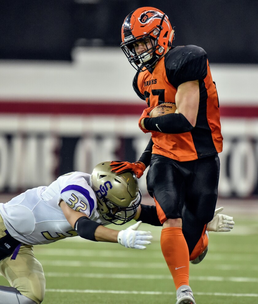 Canistota's Jerad Nielsen (27) shoves off the tackle of Sully Buttes' Cody Nelson (32) during the class 9A state championships at the DakotaDome on Thursday in Vermillion. (Matt Gade/Republic)