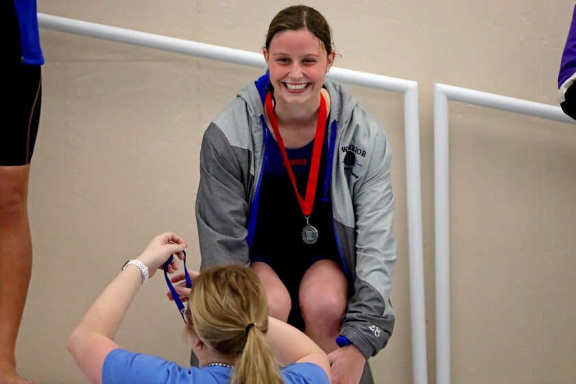 Mya Tautges smiles as she receives a medal.