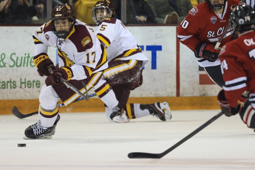 college men play ice hockey