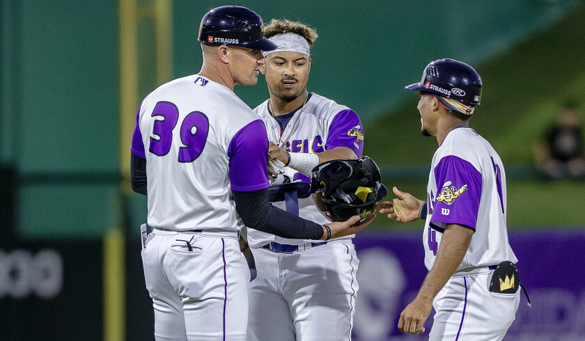 Fort Myers manager Jordan Smith talks with JP Smith II, middle, and Yilber Herrera, right, during a game against Dunedin on April 21, 2026 at Hammond Stadium in Fort Myers, Florida.