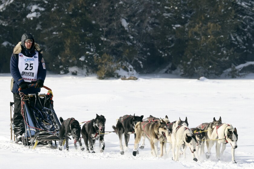 Beargrease musher crosses a lake.