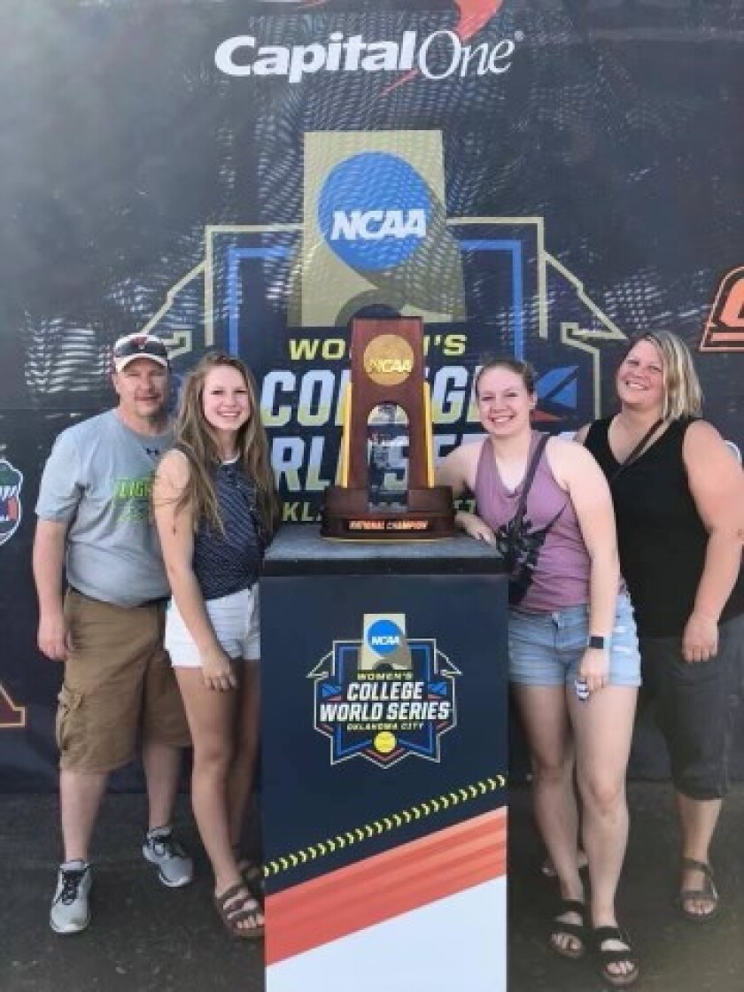 The Vaara family poses with the NCAA Division 1 softball championship trophy on a trip to Oklahoma to watch the Women's College World Series.