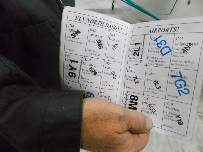 Dale Seckerson, of Jamestown, shows off a couple of pages in his completed passport