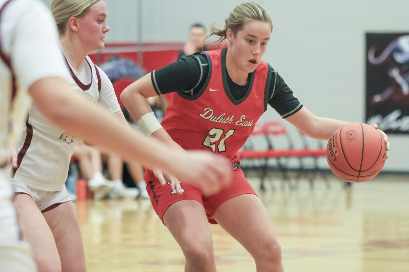 high school girls play basketball