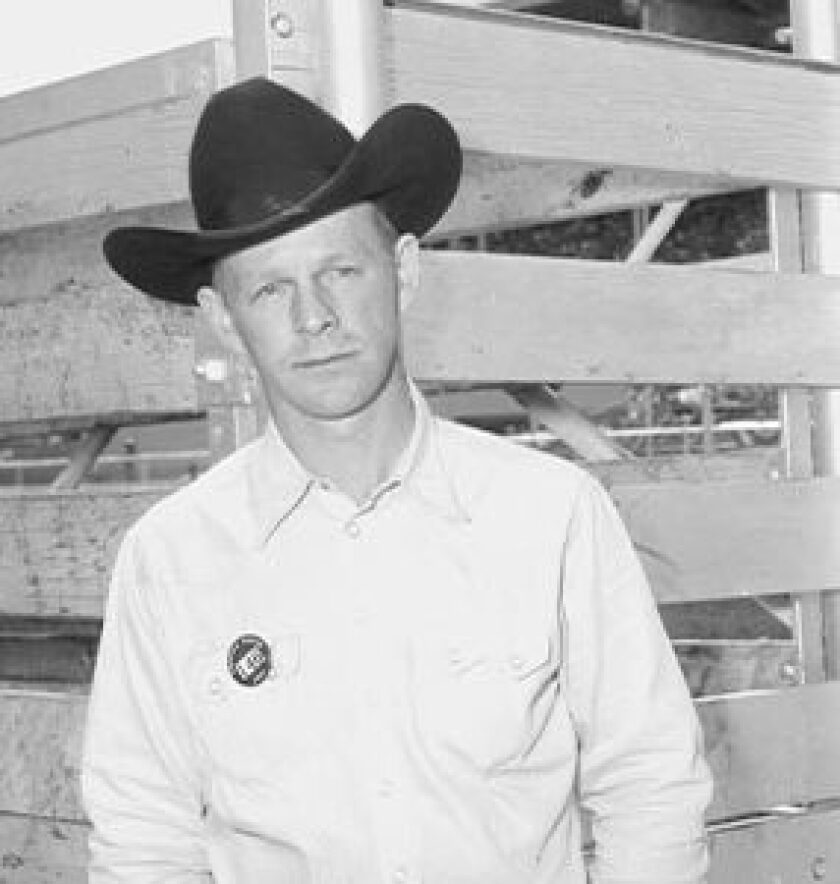 A black and white photo of a man in a cowboy hat.