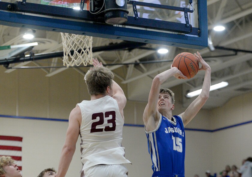 BBE sophomore Luke Illies, 15, looks to put a shot up in the paint after getting Hancock's Chase Evink to jump during a Section 6A-South semifinal game on Monday, March 13, 2023 at Minnewaska High School in Glenwood.