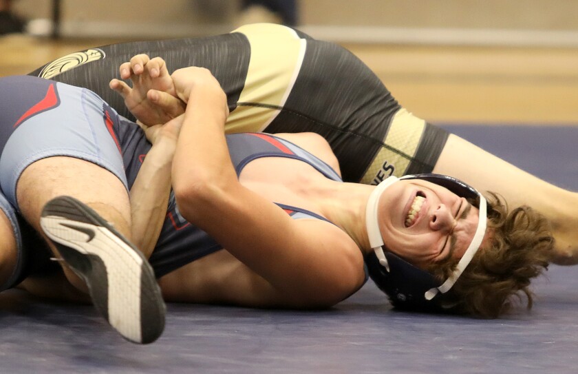 Superior’s Logan Jennings fights to get his arm back from Hayward’s Noah Christianson