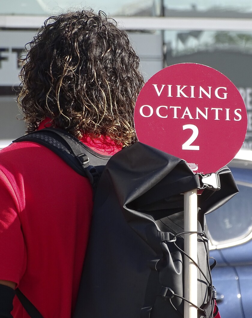 Tour guide with sign.