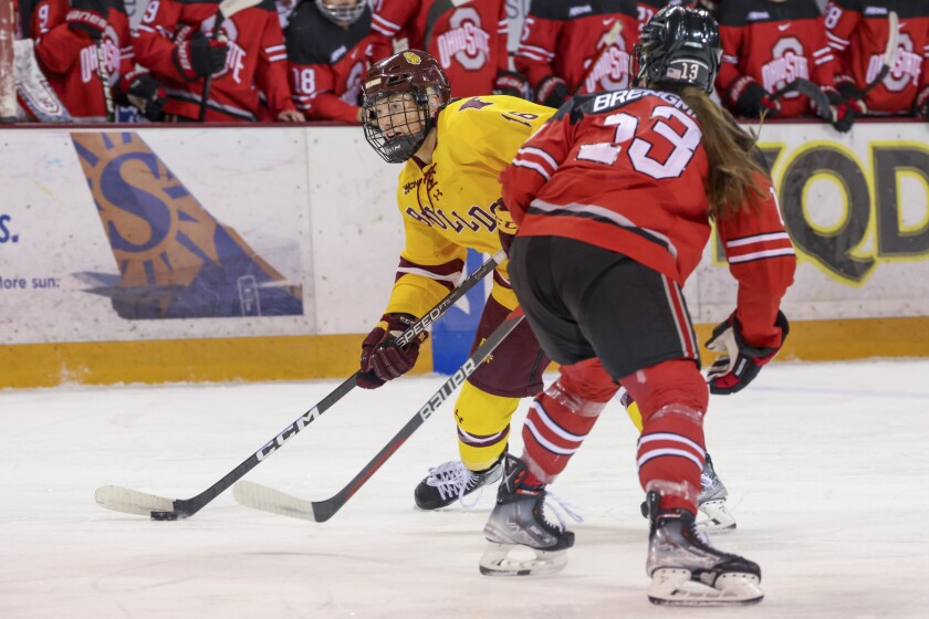 college women compete in hockey game