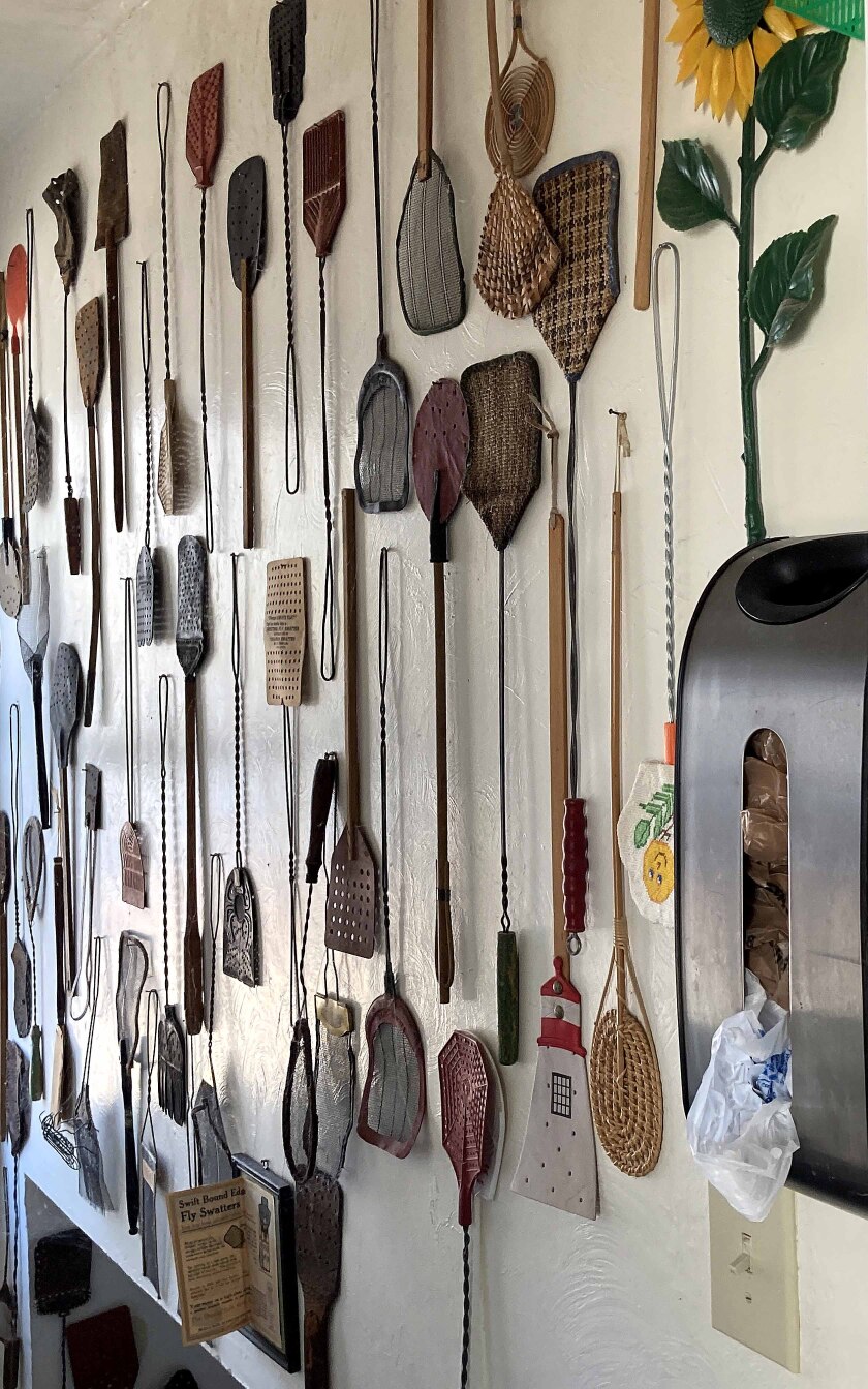 fly swatters hanging on a wall