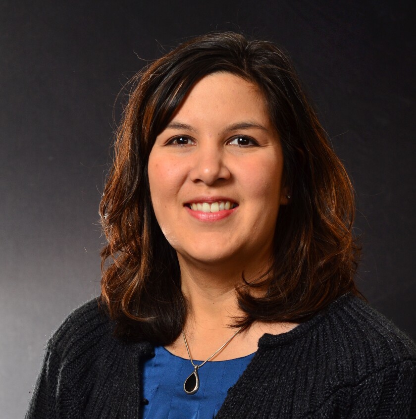 A studio professional portrait of a dark-haired woman.