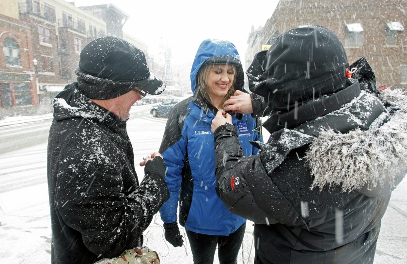 Father and son duo Mark and Chase Hentges prep for a live shot with Janel Klein for the Weather Channel