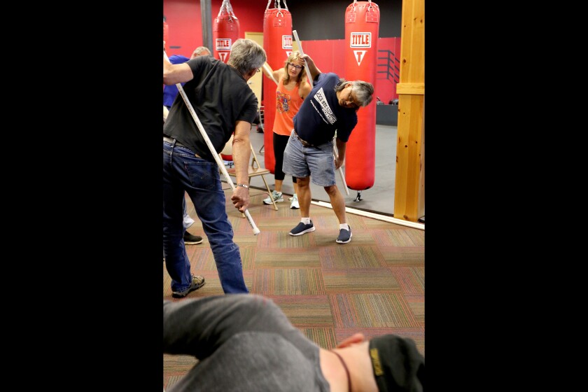Michael Erickson leads warmups Thursday during a Rock Steady Boxing class at Dion’s Dangerzone Gym in Baxter. Erickson and wife Lynda Erickson (center), who was diagnosed with Parkinson’s disease in 2012, started the class. (Kelly Humphrey, Brainerd Dispatch - Gallery and Video)