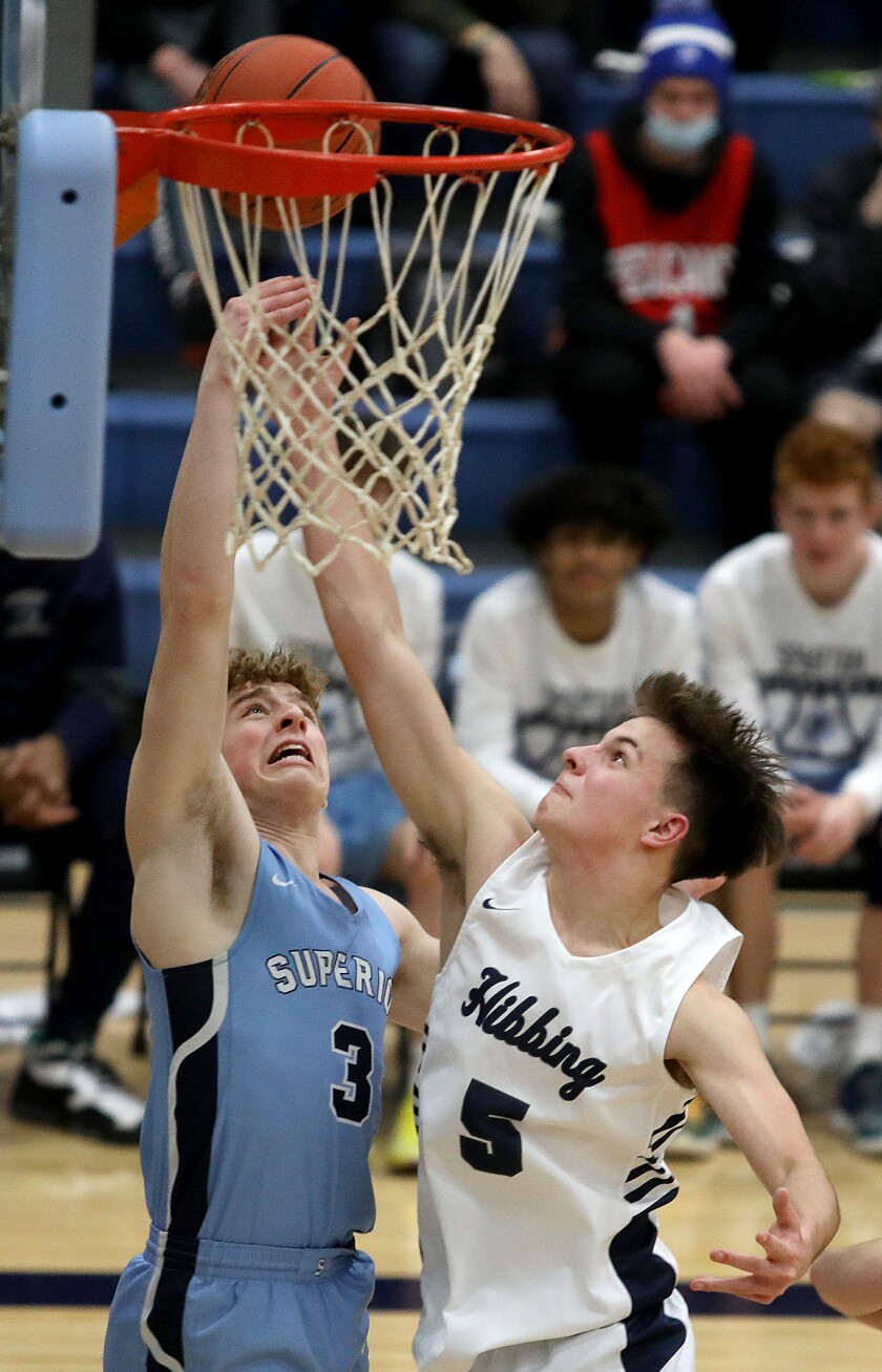 Superior’s Evan Moreau (3) and Hibbing’s Dane Mammenga (5) fight for a rebound