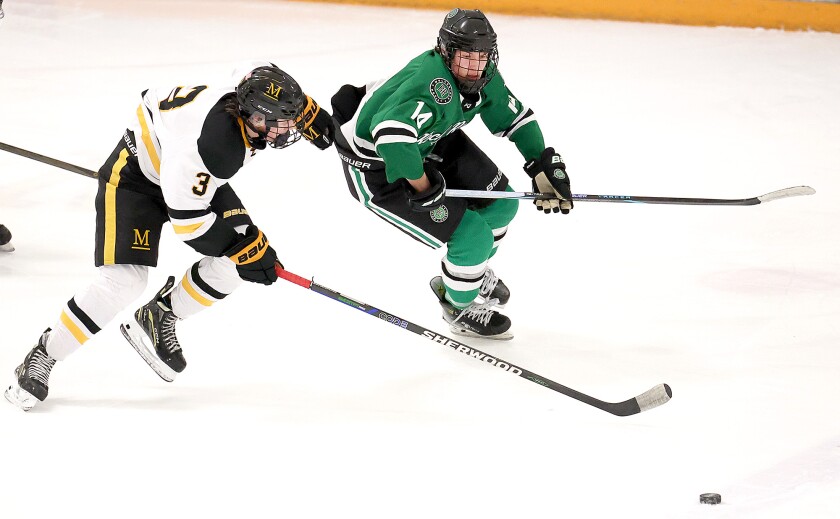 Player race to the puck.