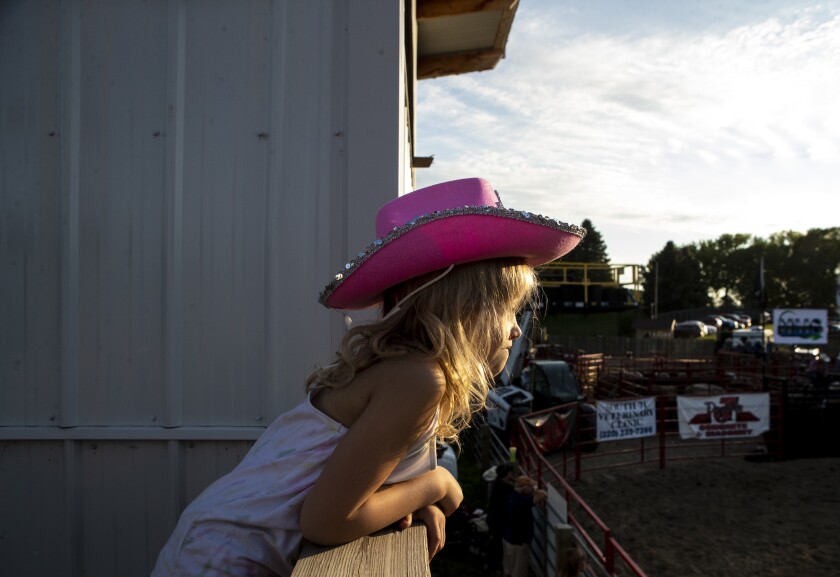 Maci Schneider, 7, watches Kandiyohi County Fair Bull Riding from atop the crow's nest at the fairgrounds in Willmar on Wednesday, August 10, 2022.