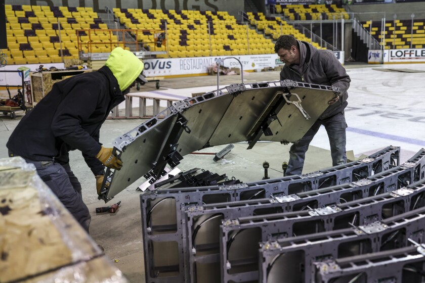 workers install new scoreboard