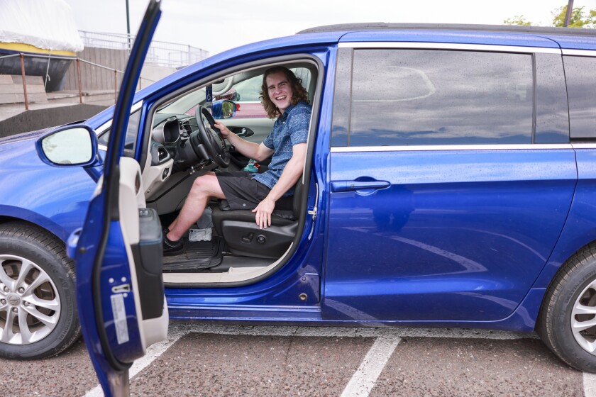 young man sits in car in Duluth