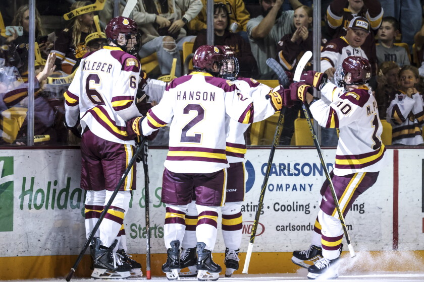 college men play ice hockey indoors