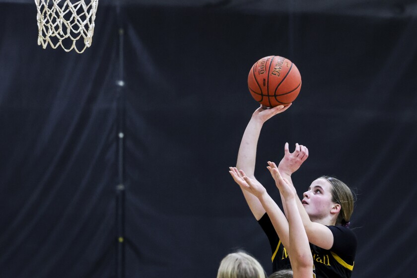 high school girls play basketball